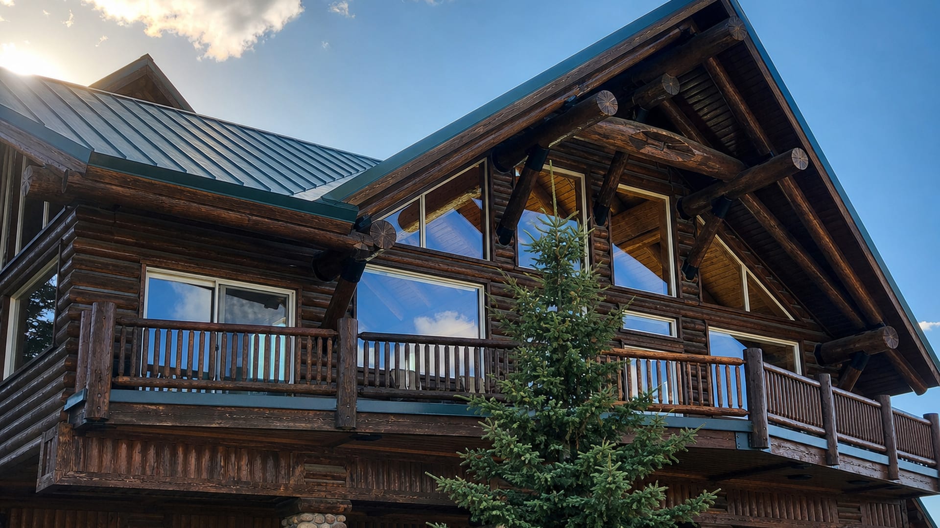 Mountain log home with large clean windows in the Heber Valley at sunset