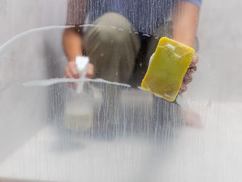 Glass being restored and cleaned of hard water mineral deposits